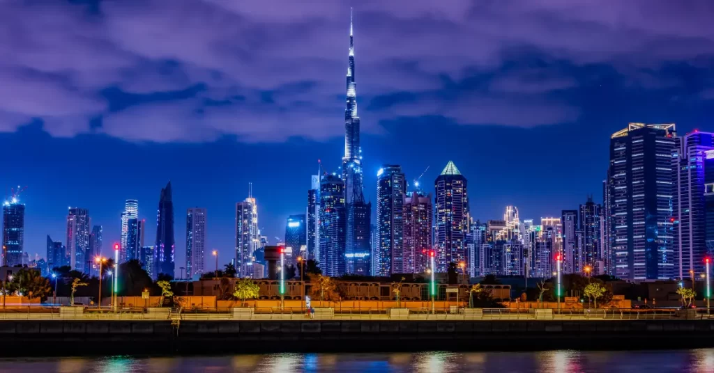 Dubai skyline at night with the Burj Khalifa and surrounding skyscrapers illuminated